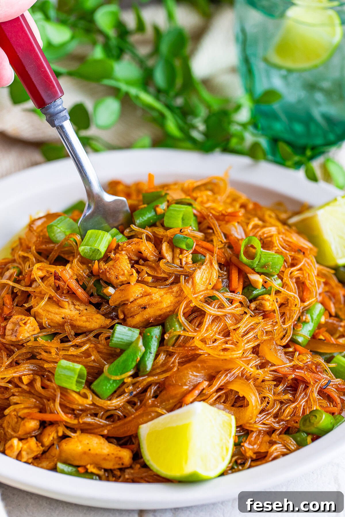 a fork grabbing a bite of Pancit off the plate