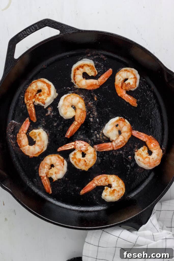 skillet with seared shrimp