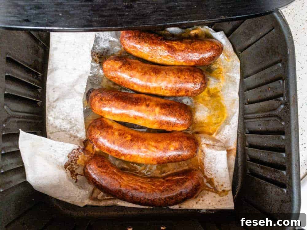 Crispy Juicy Italian Sausage in the Air Fryer 6 Italian sausage in the air fryer partially cooked and ready to be flipped