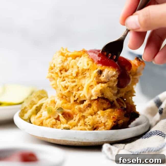 sticking fork into spaghetti squash cheeseburger bake