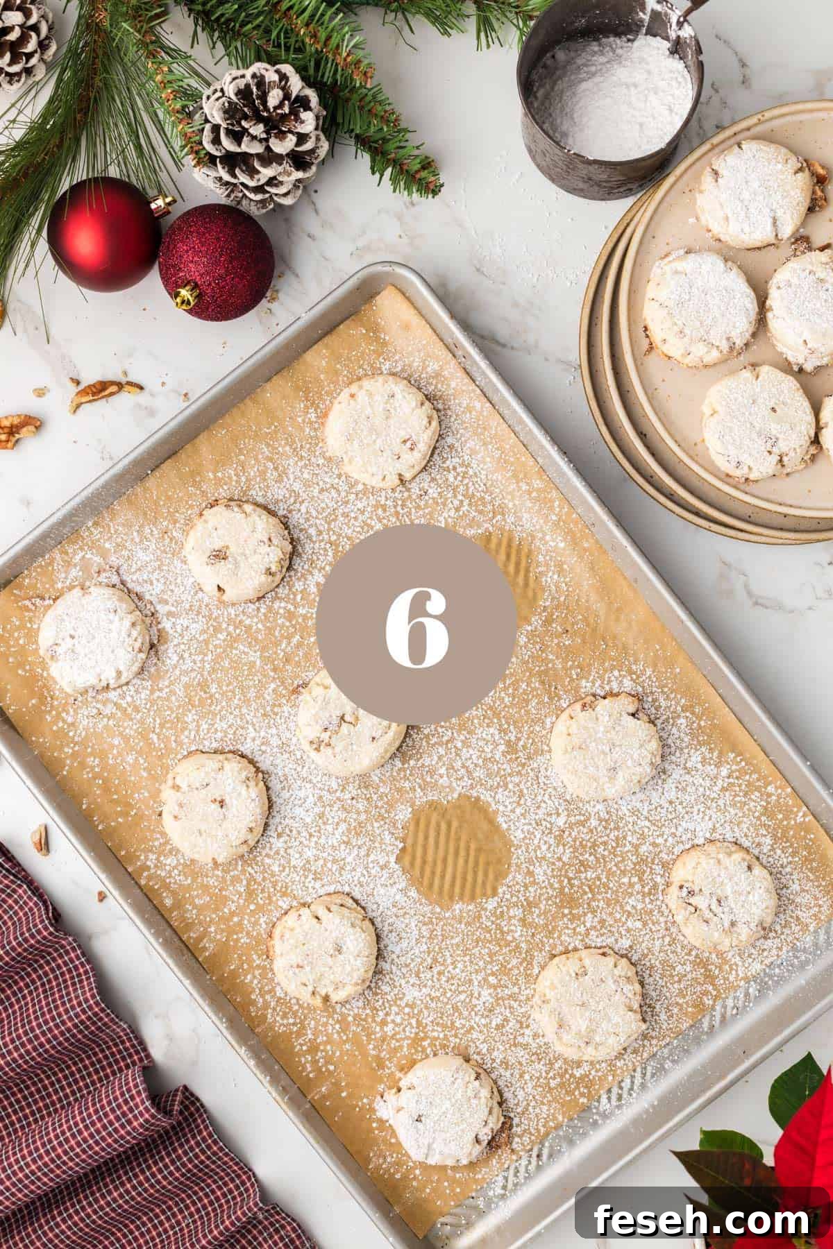 A baking sheet with a tray of baked cookies on them.