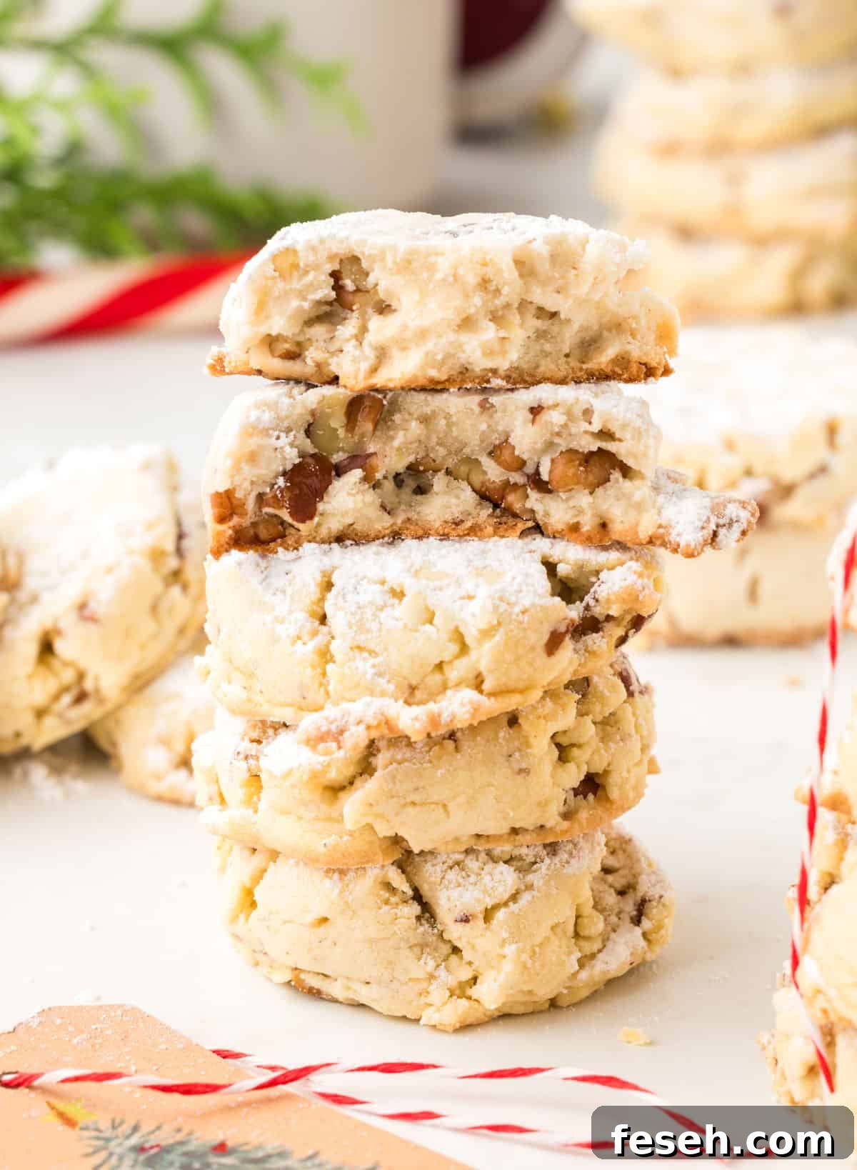 A stack of cookies with pecans in the center.