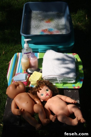 Dolls, soap, shampoo and basin of water for doll bath pretend play