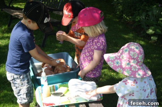 4 toddlers washing dolls