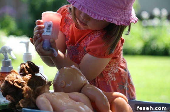 toddler squeezing shampoo on dolls hair