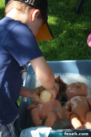 preschooler washing dolls