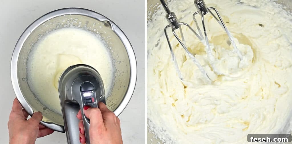 An electric mixer beating cream in a metal bowl to create whipped cream.