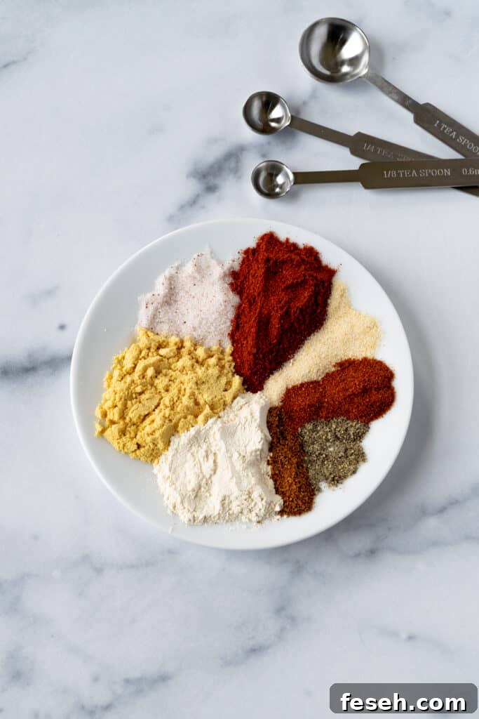 Low Country Cajun Seasoning spices on a plate with measuring spoons.