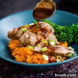 Slow cooker pork tenderloin served over sweet potato mash and drizzled with sweet spicy sauce
