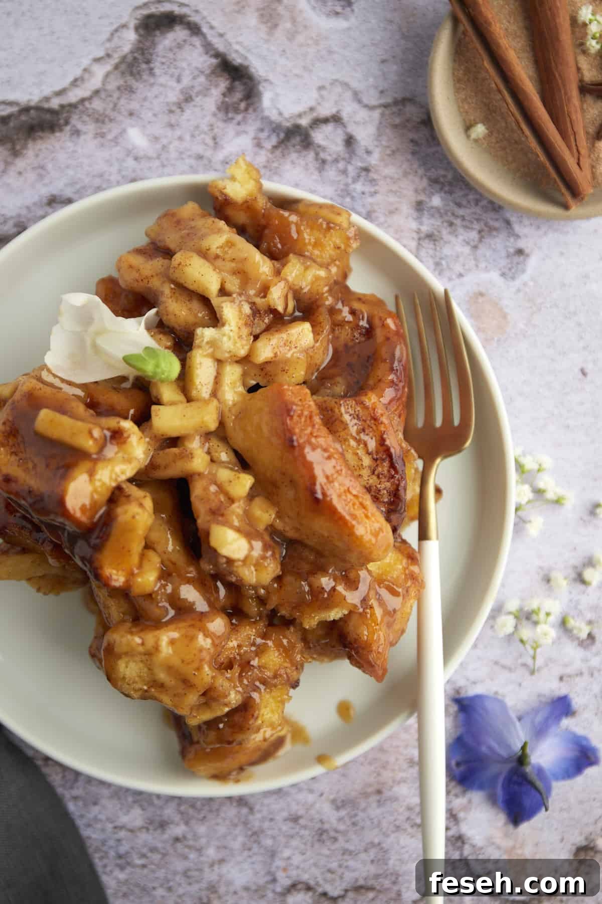 a serving of apple caramel cinnamon rolls on a plate