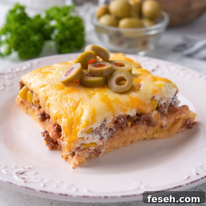 A square of cornbread taco bake on a white plate