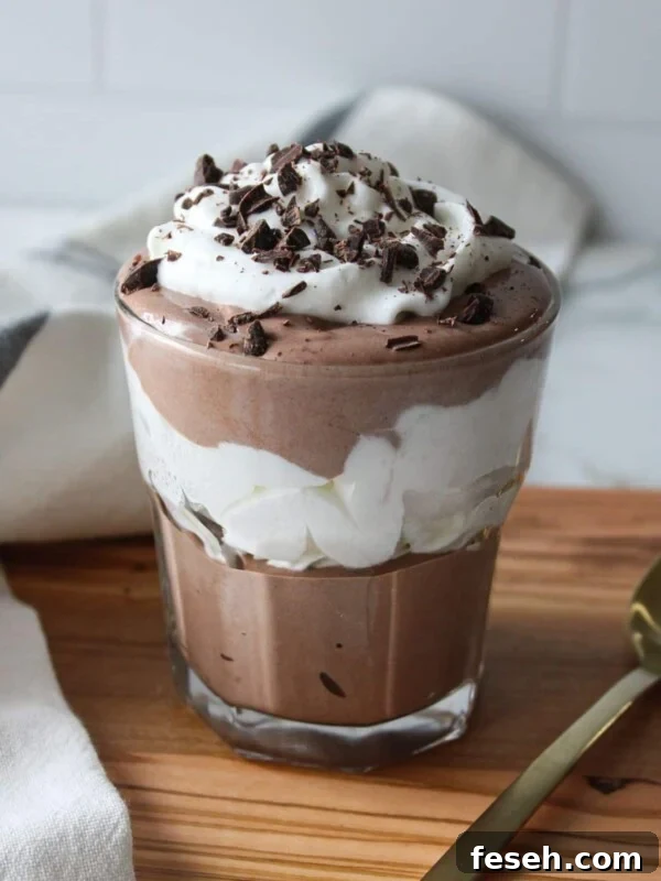 Cottage cheese chocolate mousse layered with whipped cream in a glass.