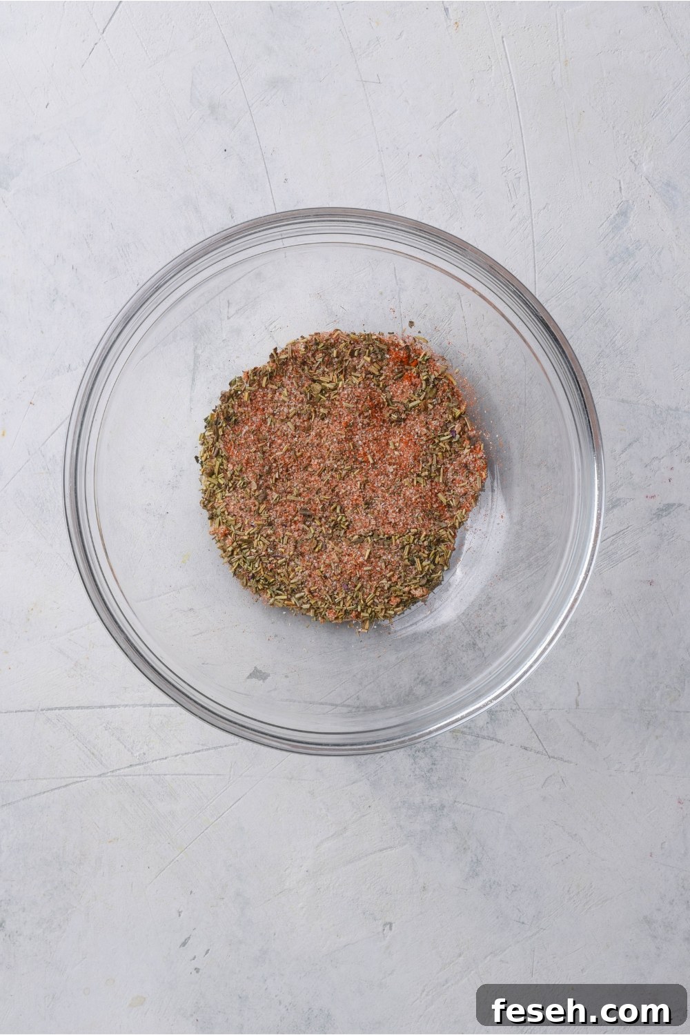 A clear bowl with a spice blend in it.