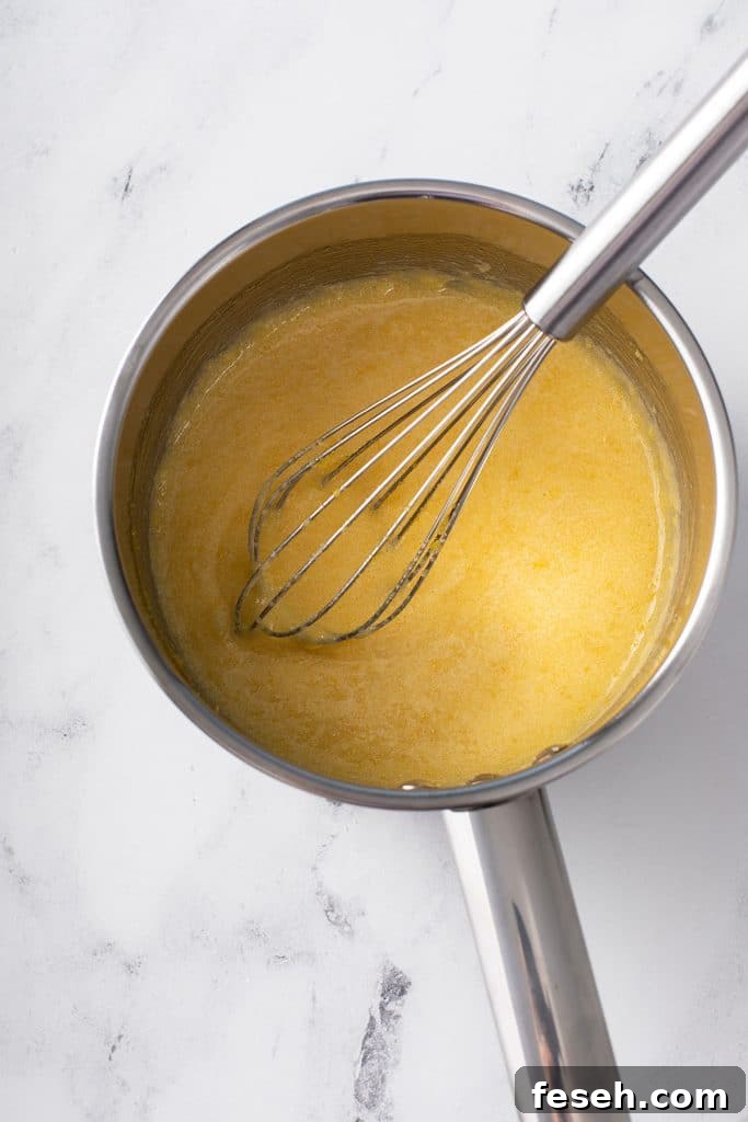 Whisking egg yolks and sugar in a saucepan
