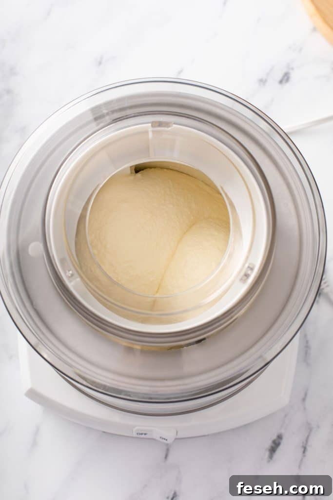 Churning lemon ice cream in an ice cream machine.