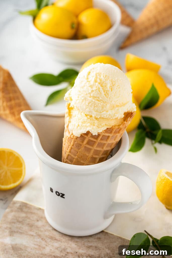 An ice cream cone with a scoop of fresh lemon ice cream.