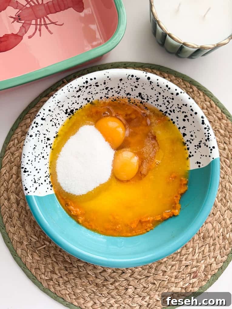 Eggs, sugar, melted butter & vanilla added to a mixing bowl.