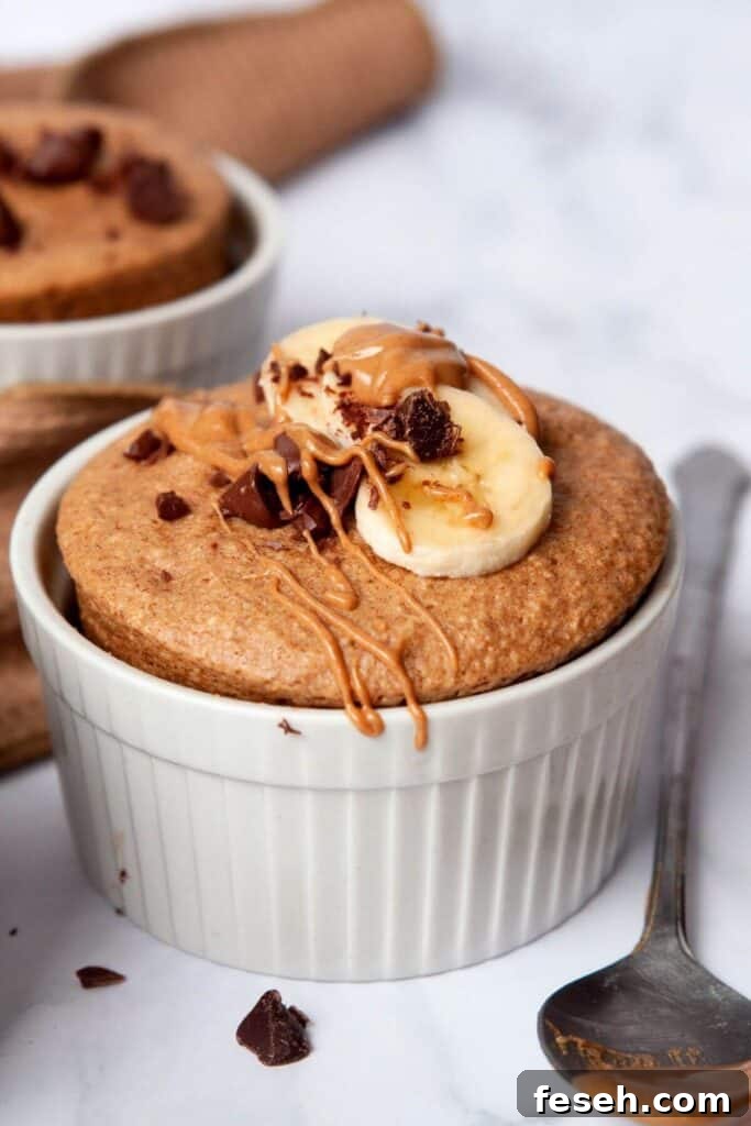 chocolate chip banana microwave baked oats with peanut butter drizzles on top