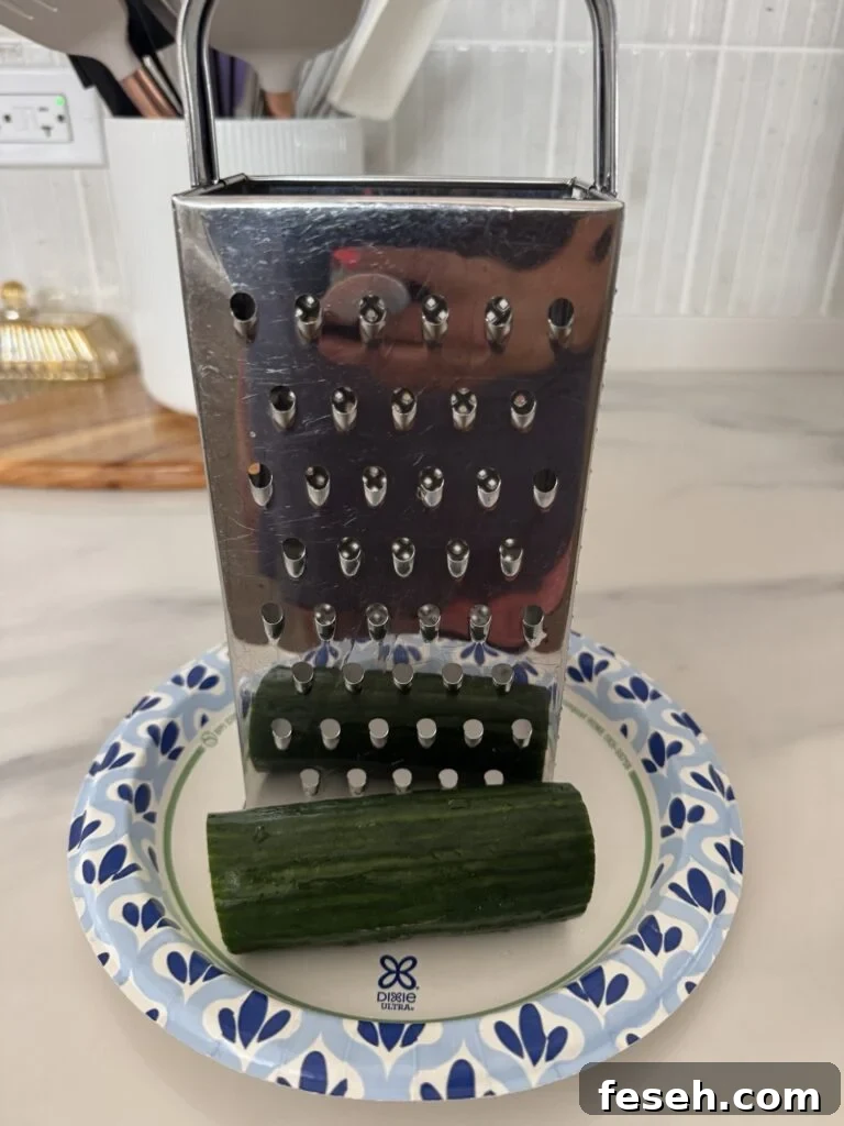 A cheese grater and cucumber