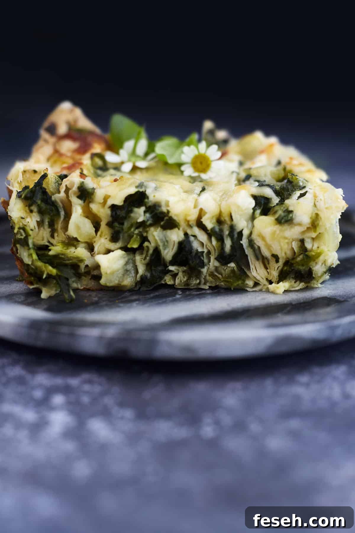a slice of crinkle phyllo stuffed with a cheesy spinach mixture.
