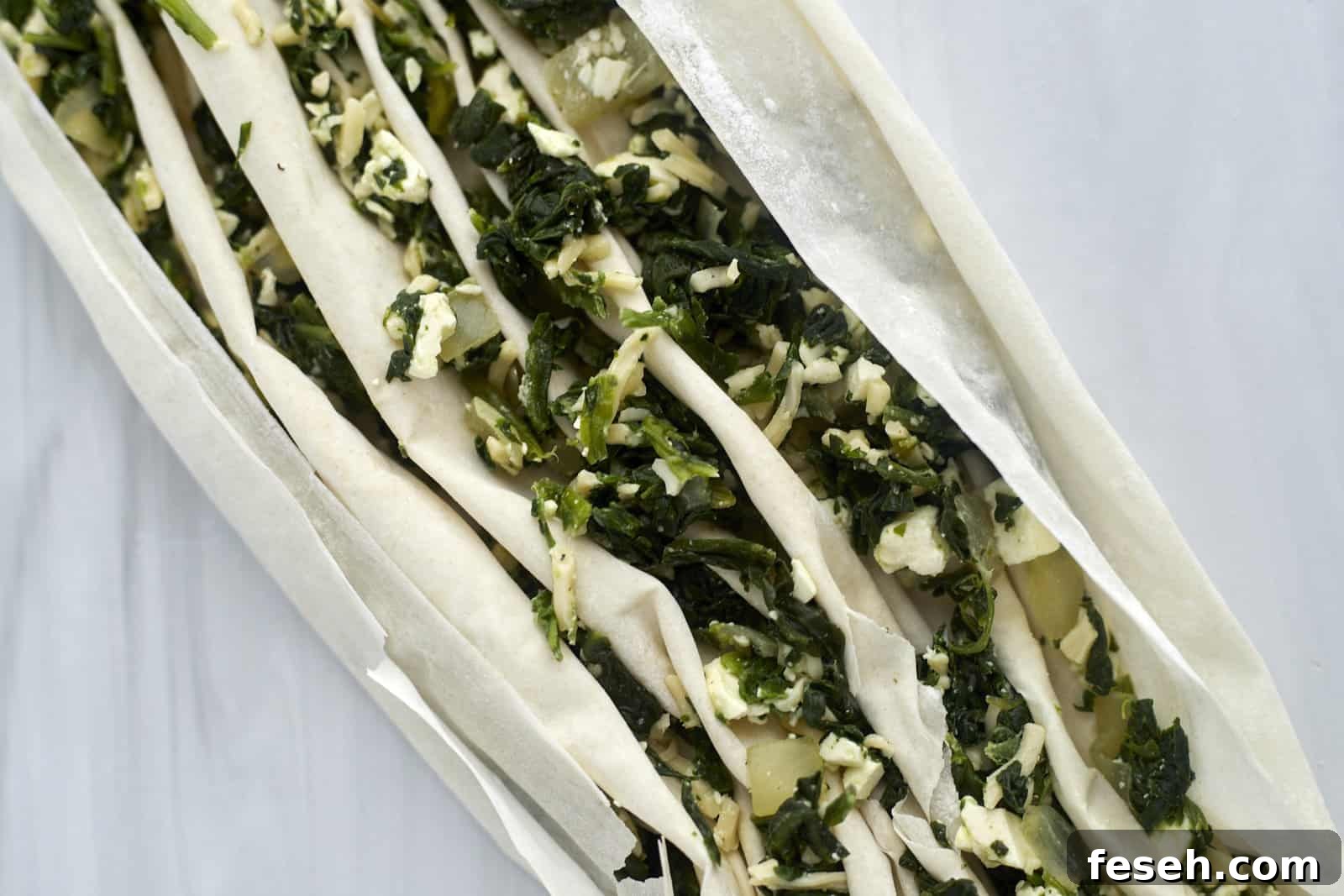 crinkle phyllo dough stuffed with spanakopita filing.