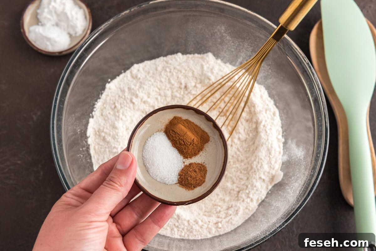 adding spices to flour in a bowl