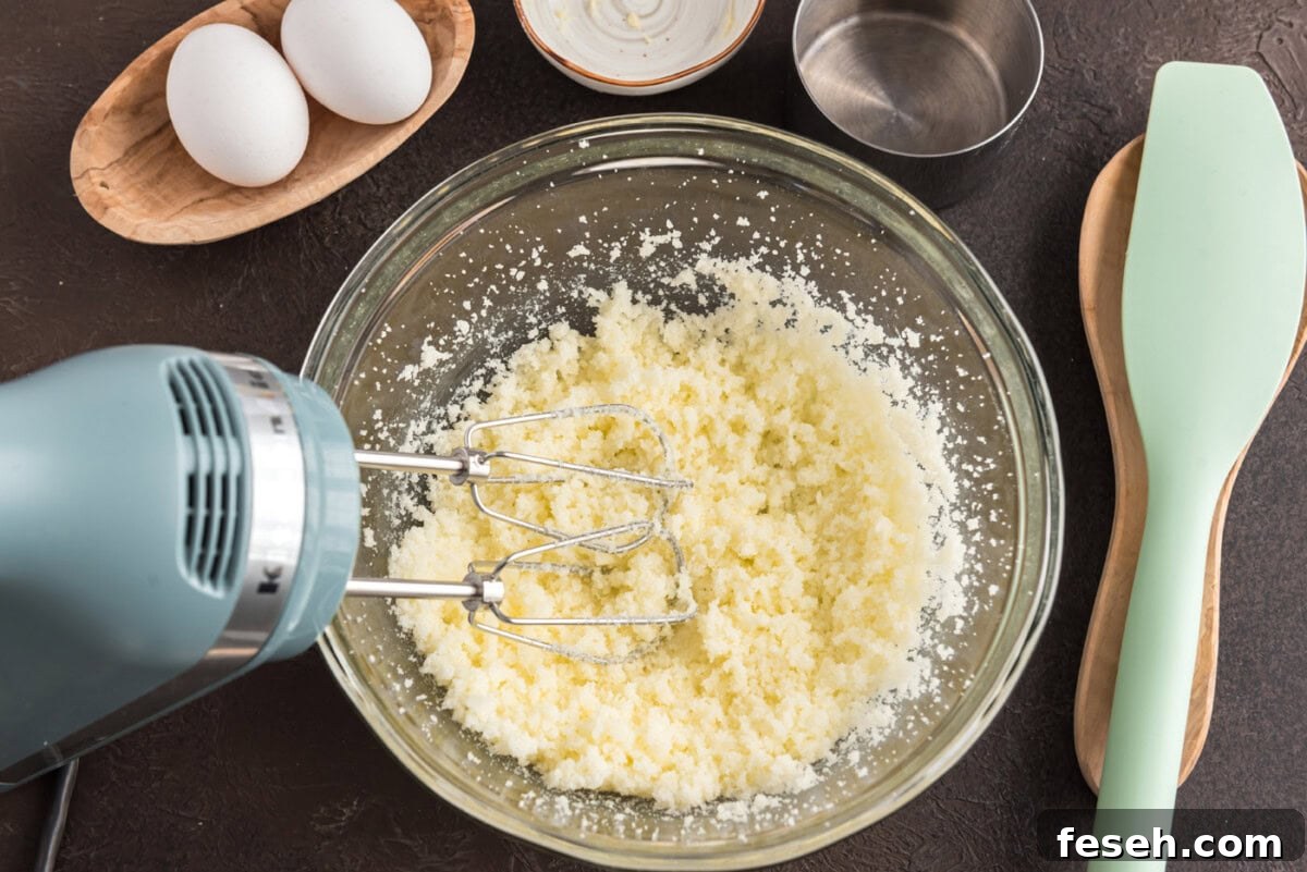 mixer beting butter in a bowl