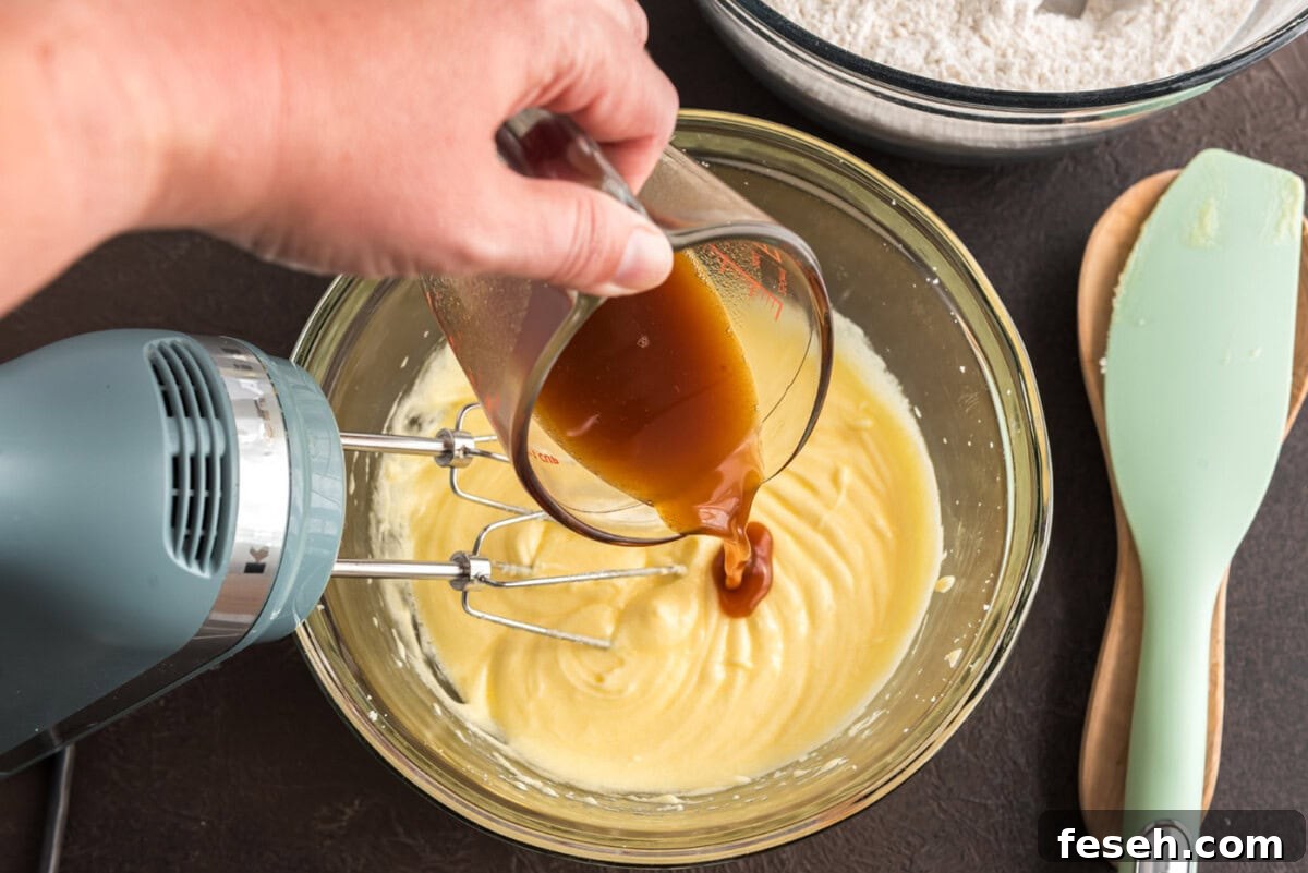 pouring apple cider into doughnut batter