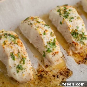 Baked halibut on a baking sheet.