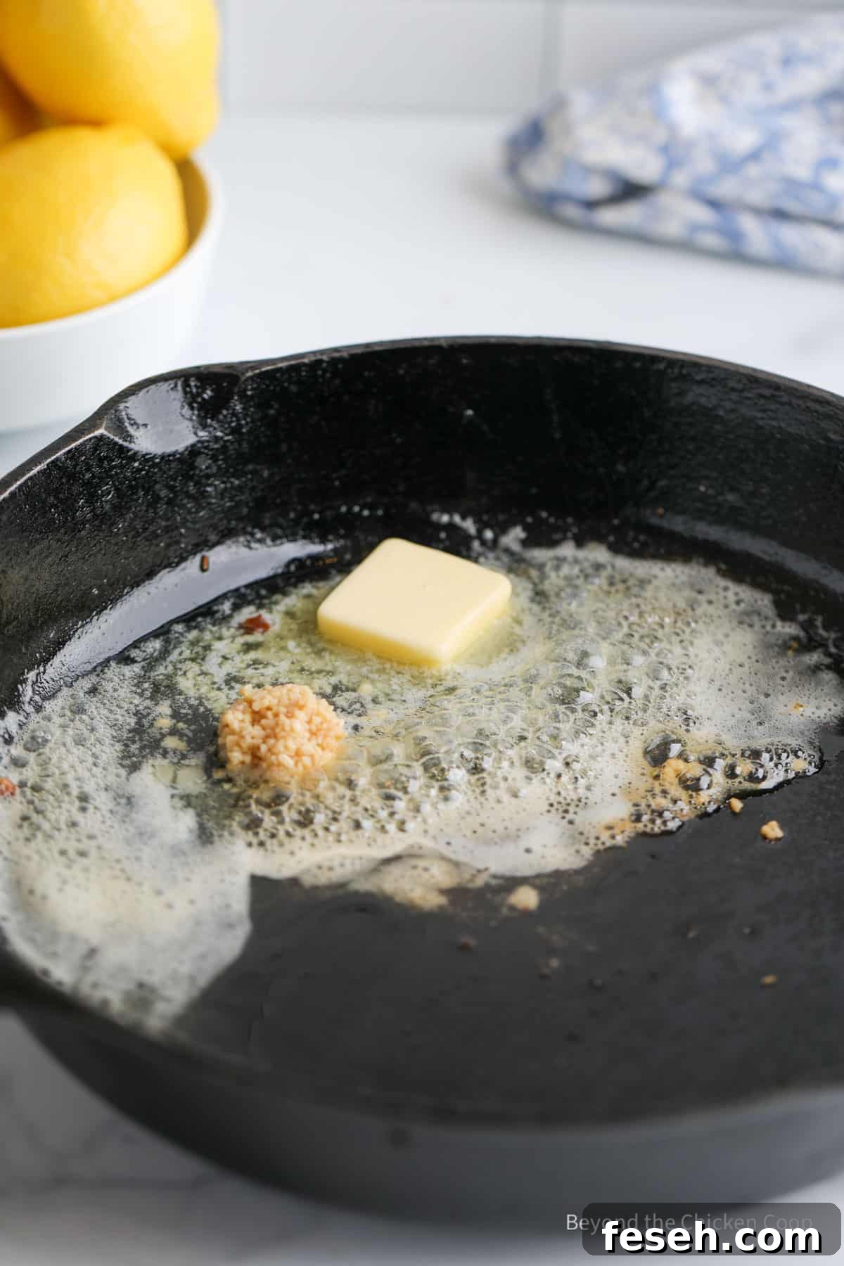 Butter, garlic and capers in a pan.