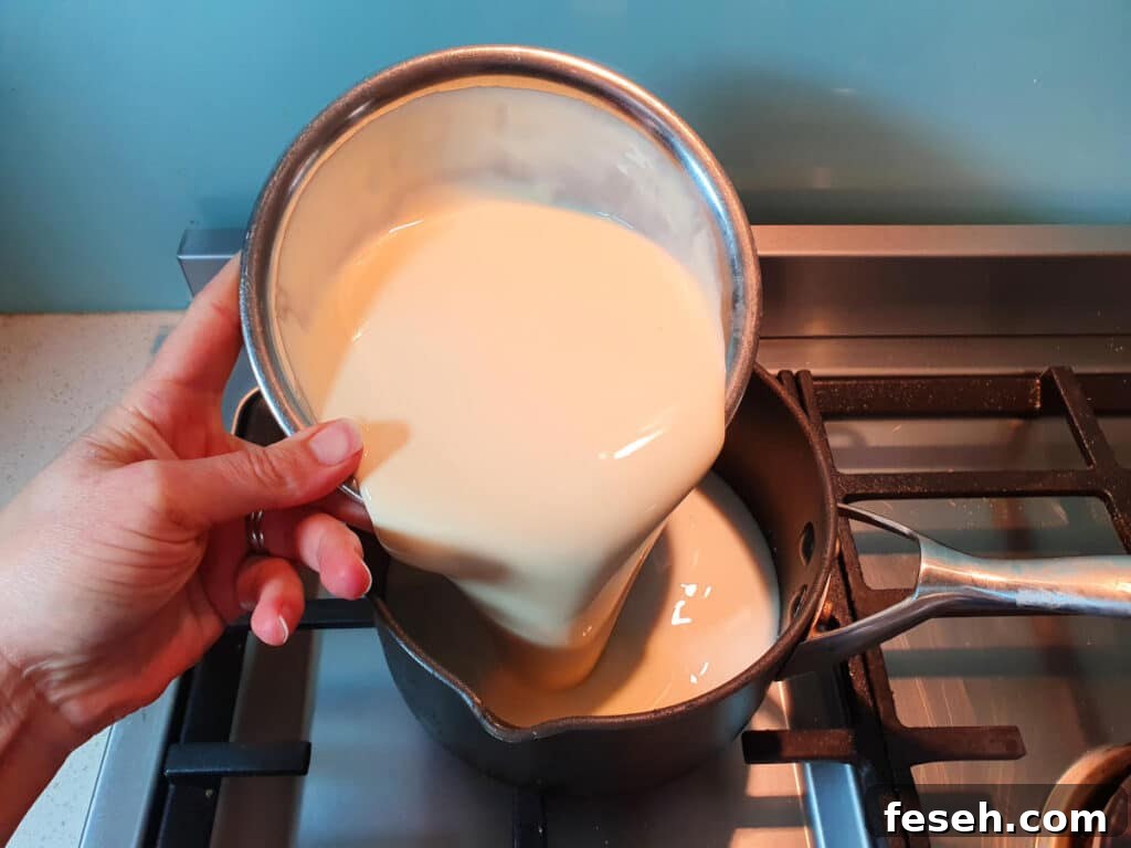adding cream to pot on stove.