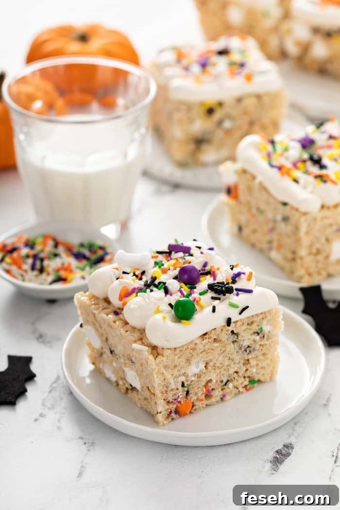 Plated halloween rice krispie treats next to a glass of milk