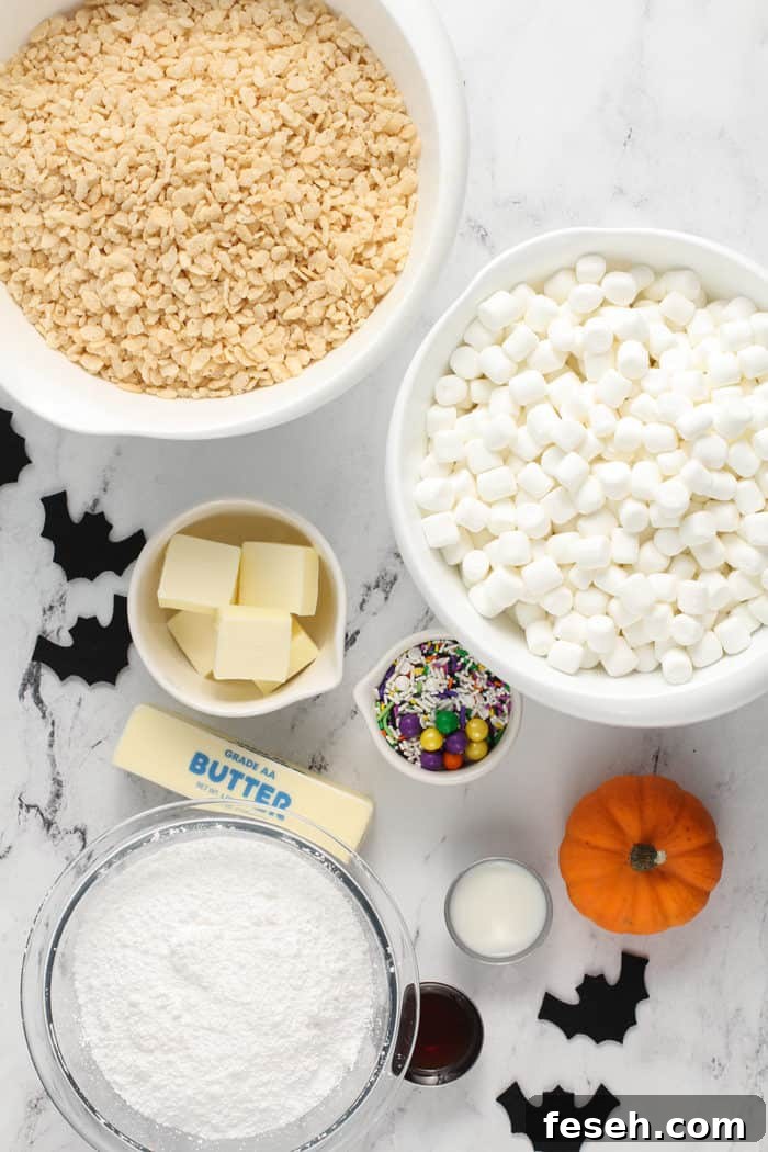 Ingredients for Halloween rice krispie treats arranged on a marble counter