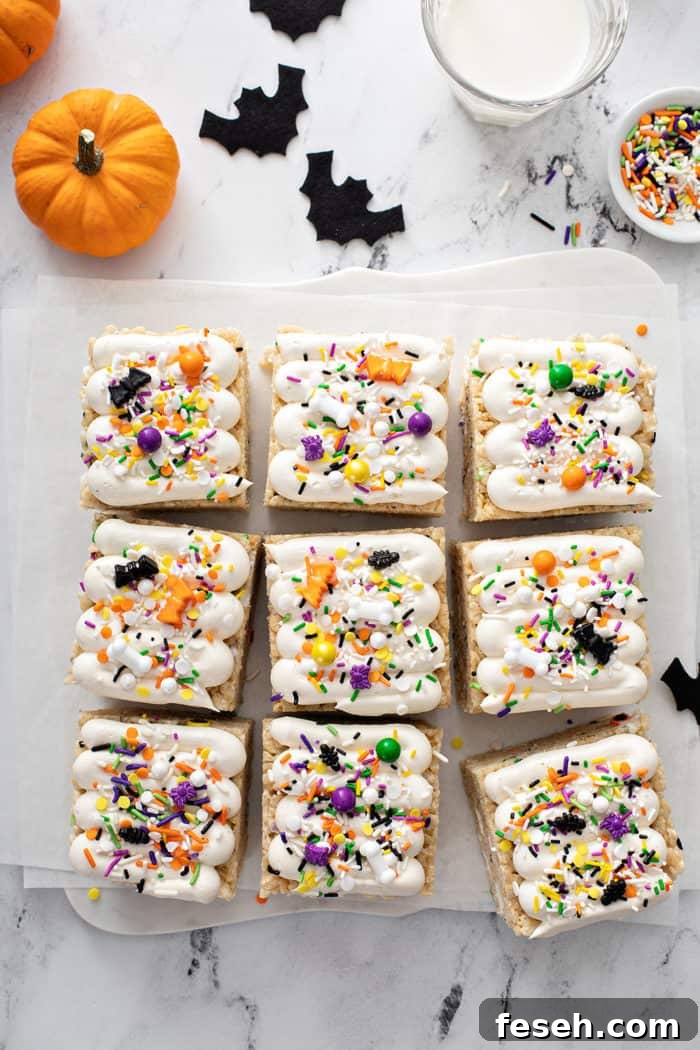 Overhead view of sliced and frosted halloween rice krispie treats on a piece of parchment paper