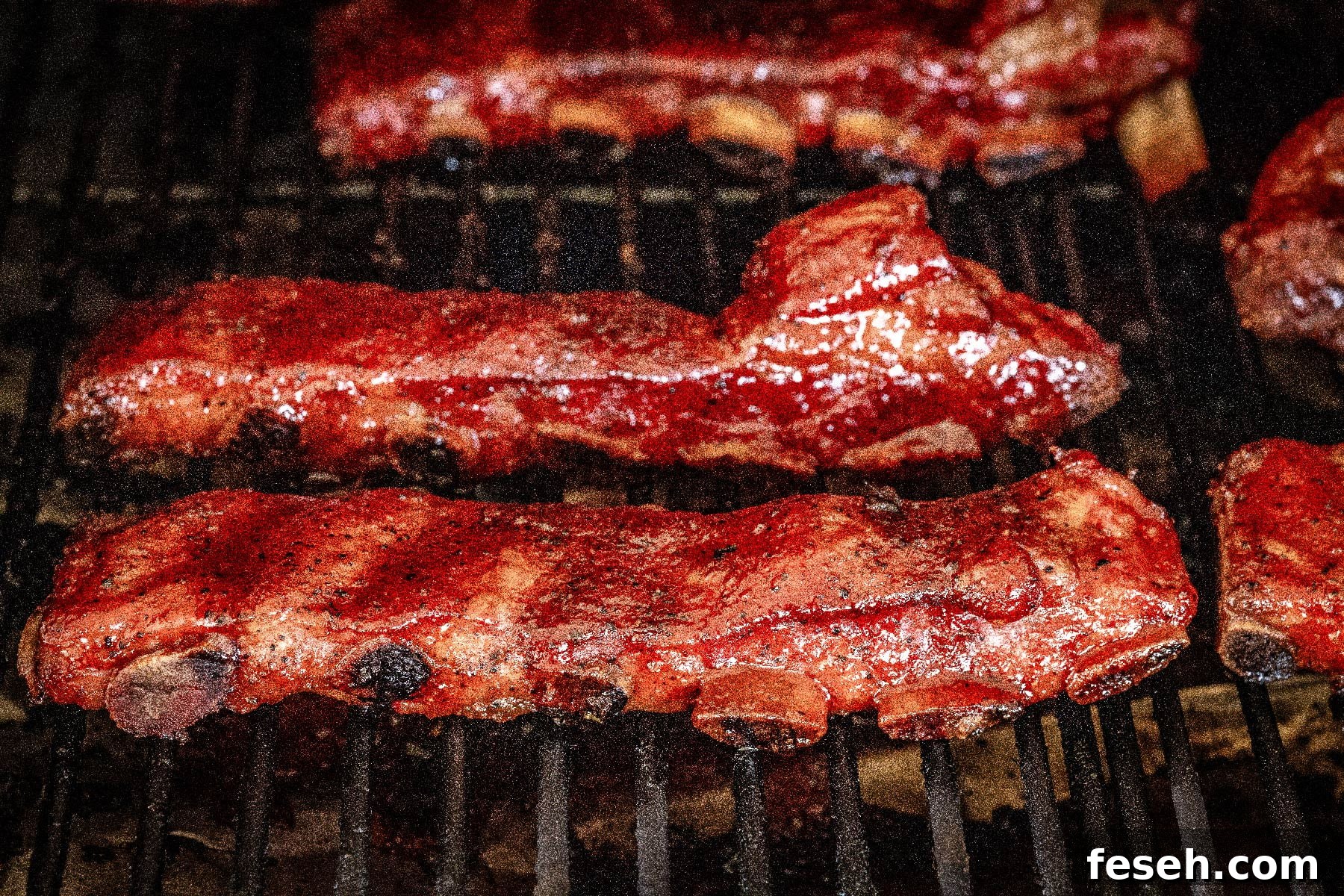 Ribs smoking on grill grates.