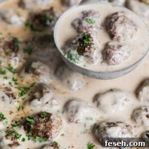 Ladel full of homemade swedish meatballs in sauce