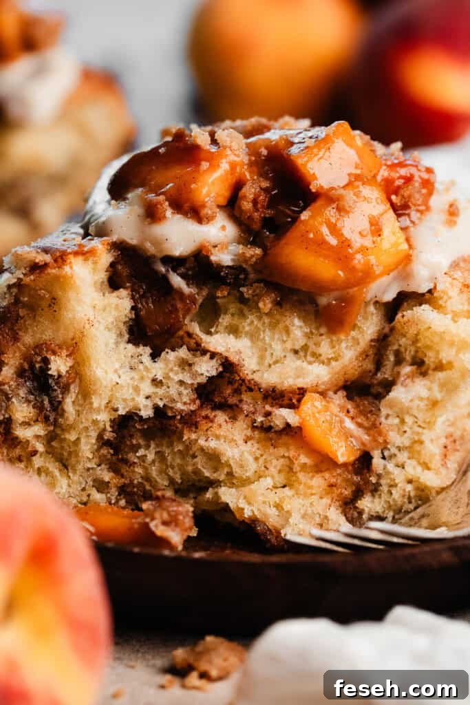 A close-up of the fluffy inside of a peach cinnamon roll.