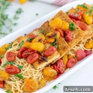 completed Tofu Fillets with Tomato Herb Sauce in a white serving platter against a white background