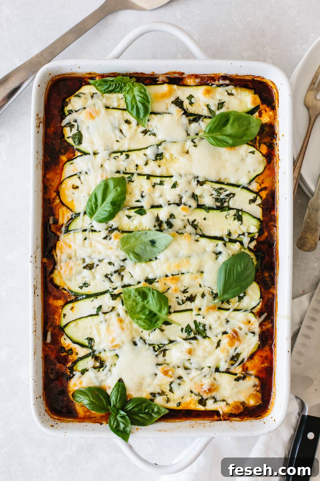 Zucchini lasagna in a white casserole dish.