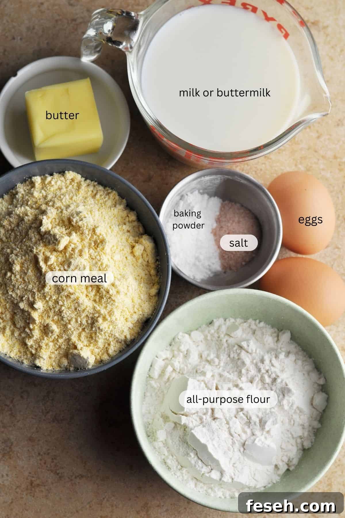 Ingredients for cornbread, including flour, corn meal, salt, baking powder, butter, milk or buttermilk, and eggs.