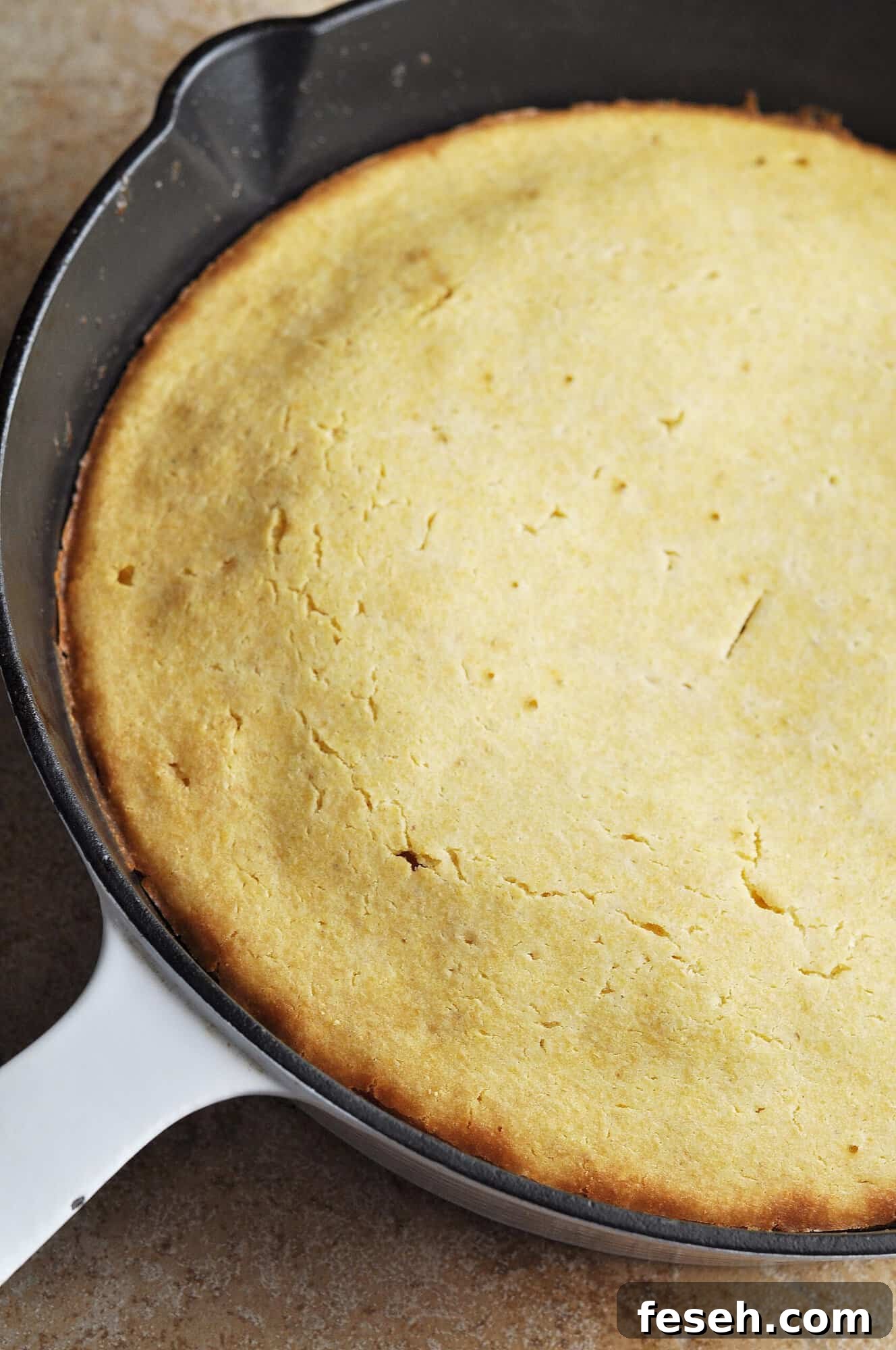 Cooked cornbread in cast iron skillet.