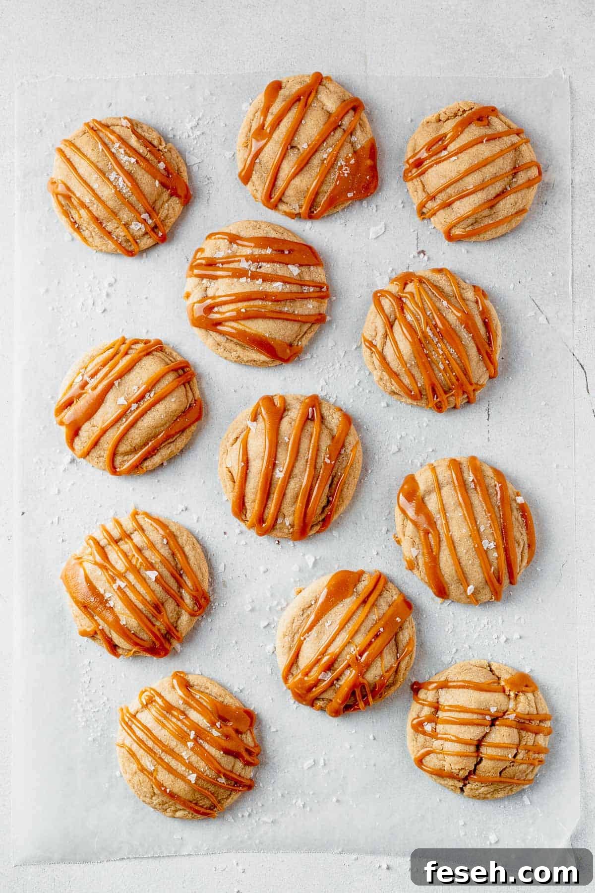 caramel cheesecake cookies cooling on parchment paper