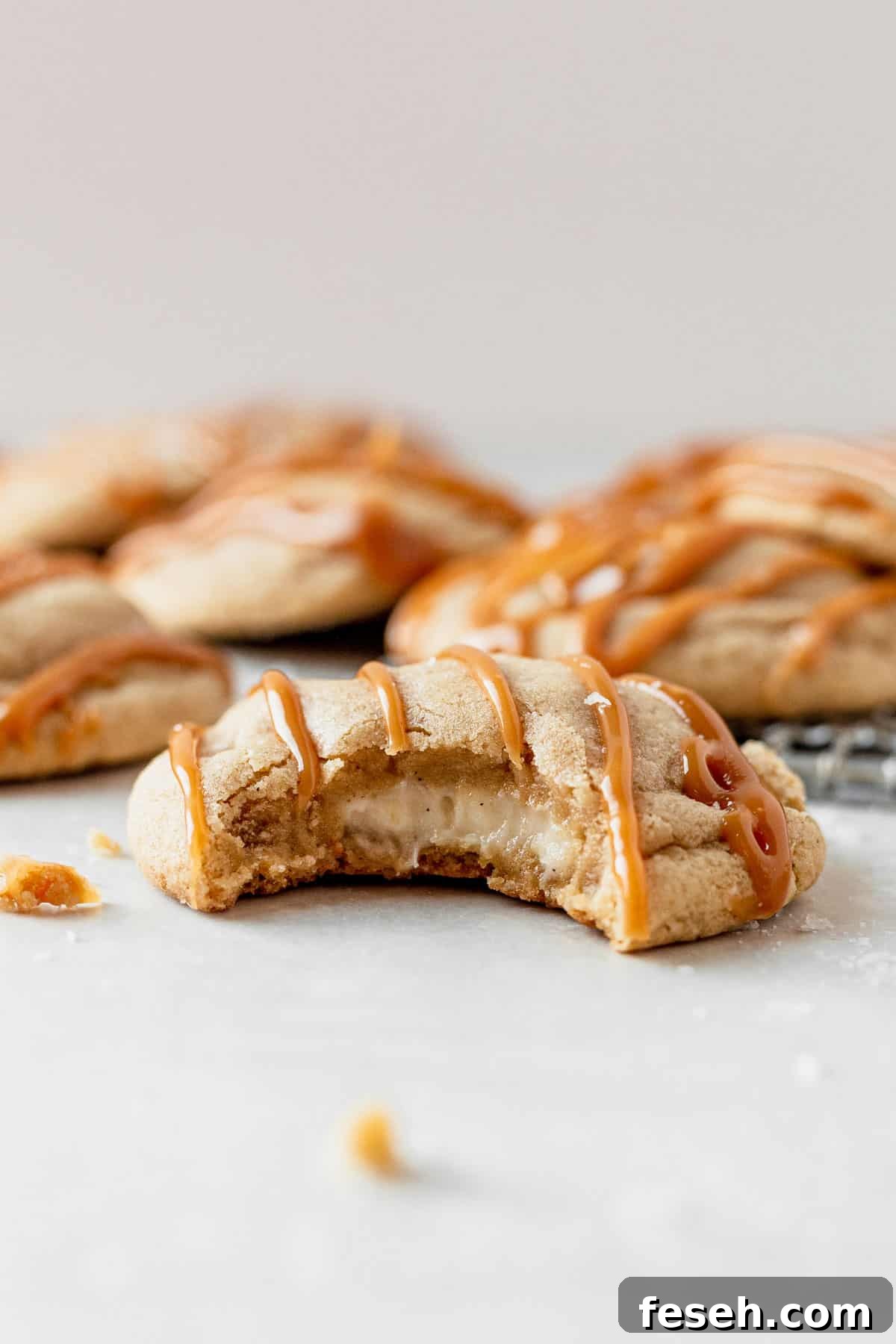 caramel cheesecake cookie with a bite taken out of it
