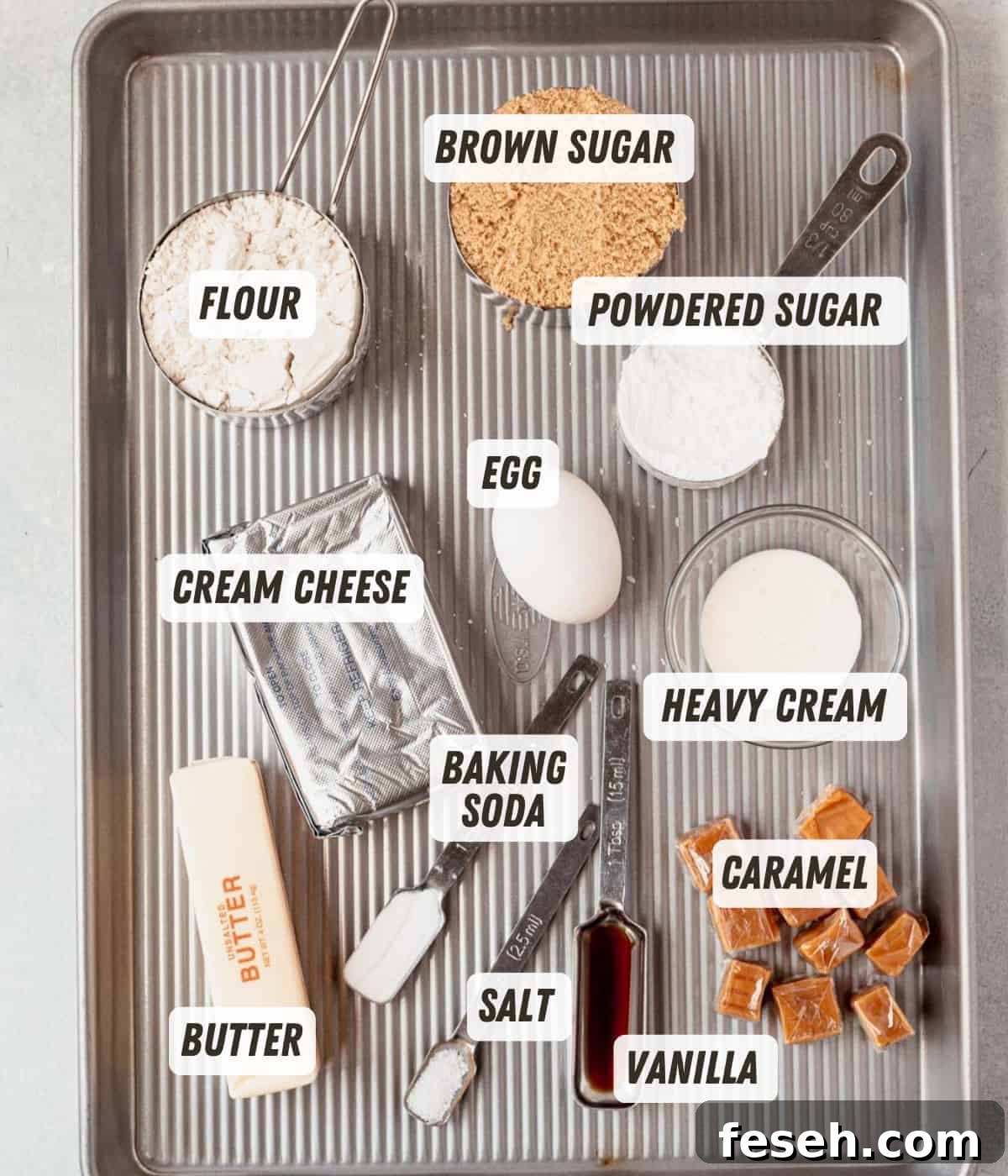 flour, cream cheese, brown sugar, butter, egg, baking soda, and caramels on a sheet pan
