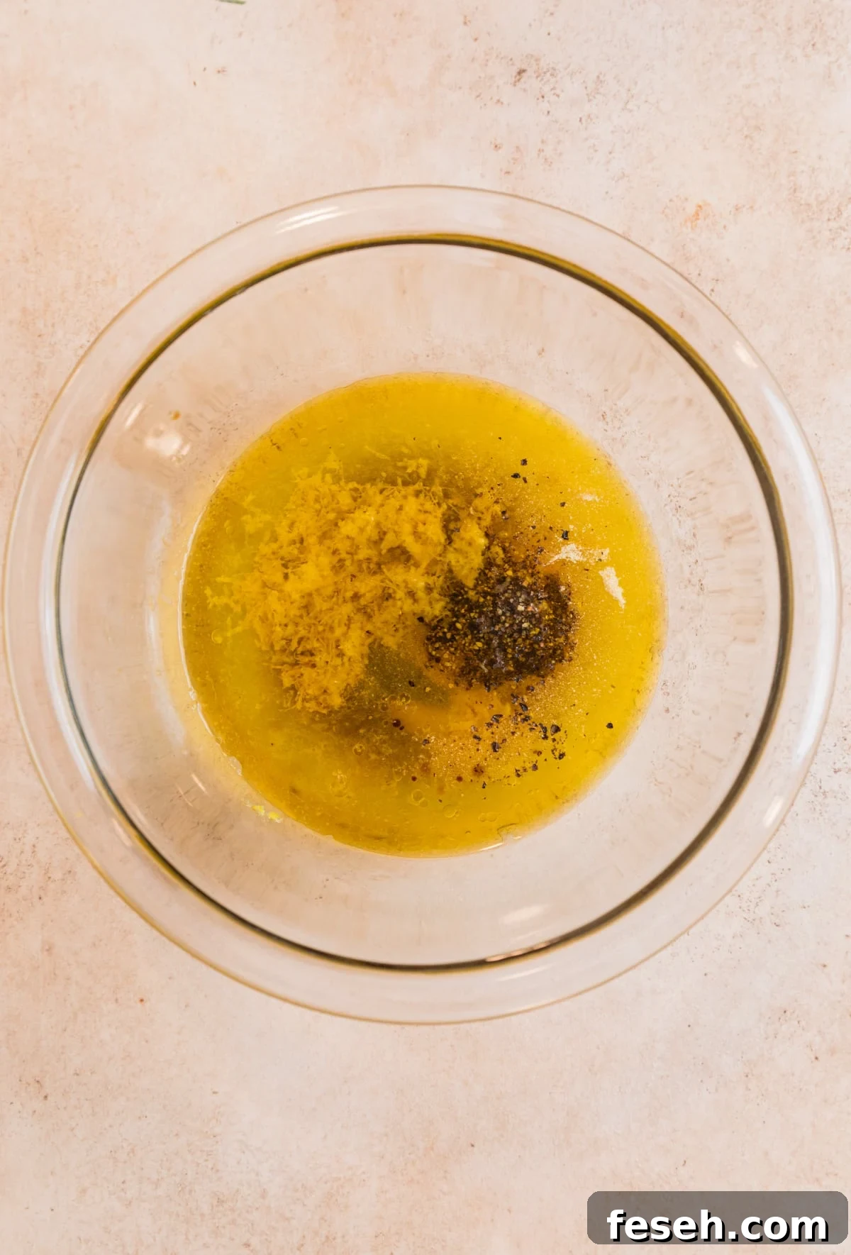 Lemon pepper marinade ingredients in glass mixing bowl.