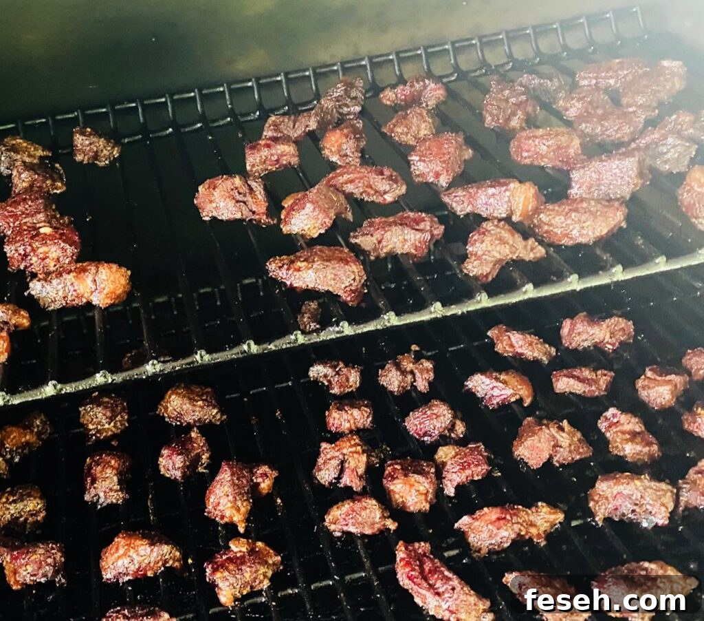 cubes of steak on smoker after cooking