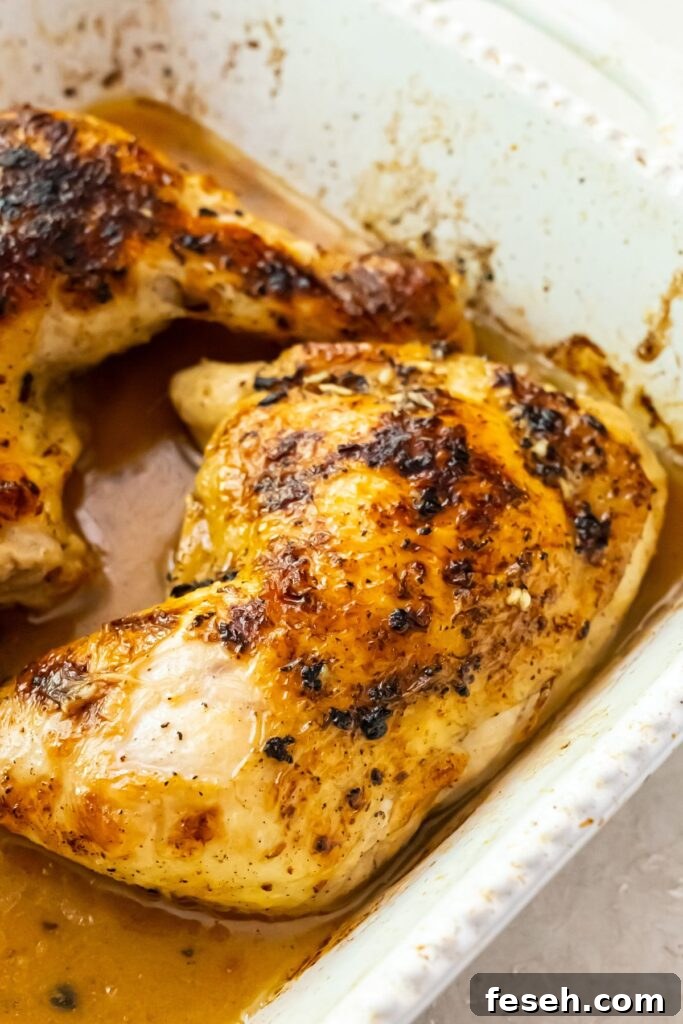 broiled chicken quarters in a white baking dish