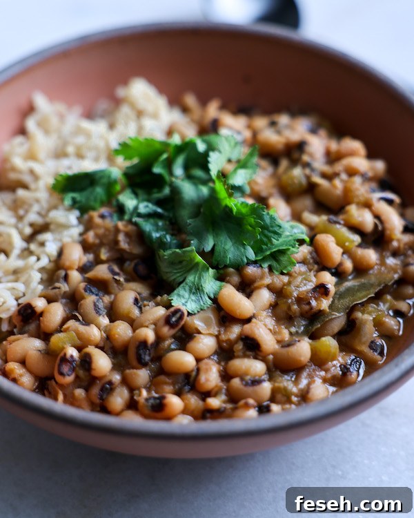 A close-up shot of a bowl of black-eyed peas and rice.