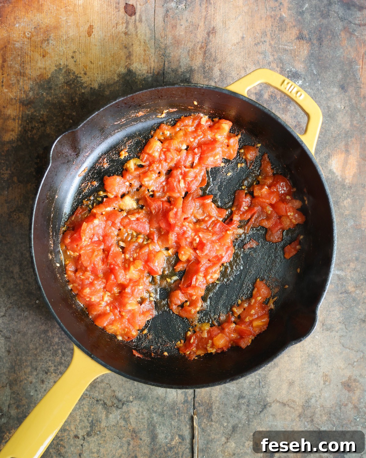 Tomatoes sautéed in a skillet.