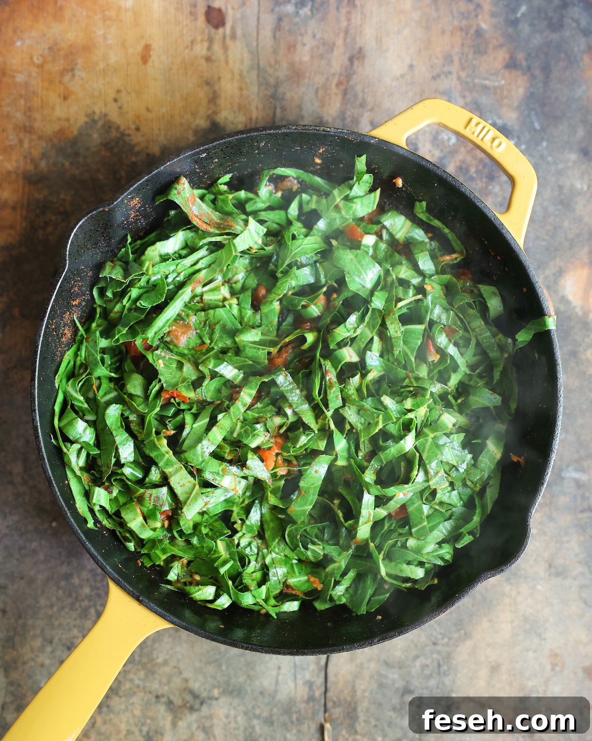 Collard greens sautéing in skillet.